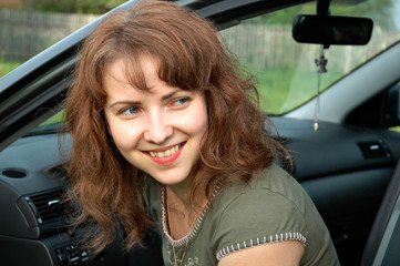 Fototapeta na wymiar Portrait of the lovely girl in the car