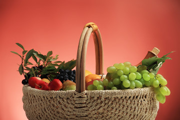 Berries and wine composition in a basket.