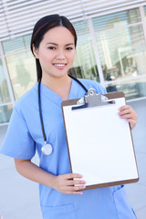 A pretty young asian woman nurse in front of hospital