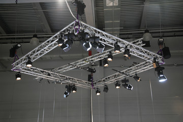 Projectors on a stage under a ceiling
