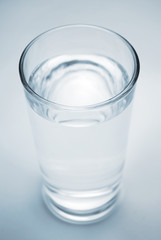 Fresh cool glass of water on a blue background