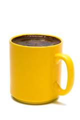 Yellow mug from coffee on a white background