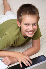 Fototapeta premium Boy learning at home with notebook