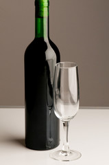 Bottle and wine glass on dark background