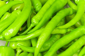 Many green hot peppers arranged at the market