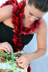 Gorgeous young woman unwrapping a Christmas present.
