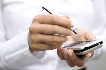 Woman using palmtop, close-up