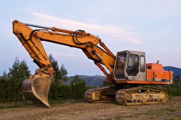 Fototapeta na wymiar A big orange bulldozer at construction site