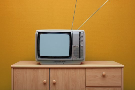 Vintage TV set, orange wall