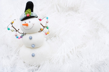 Snowman on white shiny garland making a background