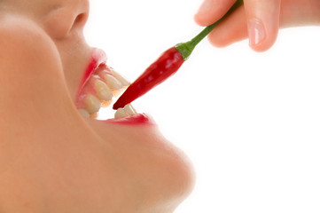 Girl with chili peppre between the teeth