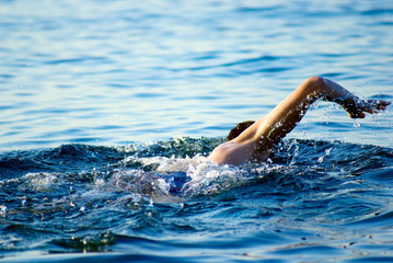 swimming man in ocean water