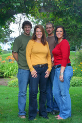 family of four brothers and sisters outside in a park