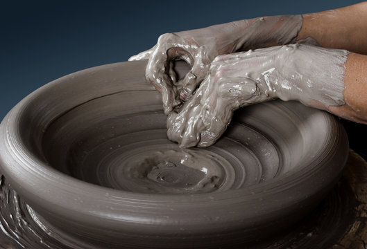 Close-up picture of a potter works a potter's wheel