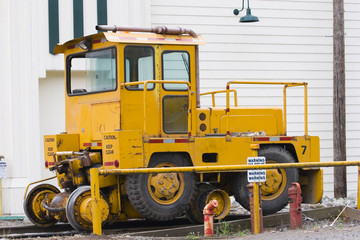 A larg yellow railroad track utility vehicle