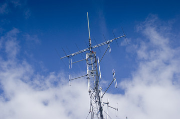 Radio communications tower isolated against blue sky