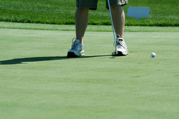 A Golfer putting on the green