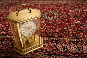 Antique clock on persian rug