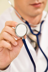 Close-up of male doctor&rsquo;s hand holding stethoscope