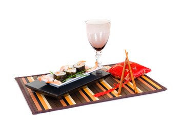 Plate with traditional Japanese sushi, sashimi rolls.