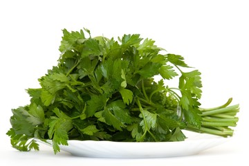 Green dill on a plate on a white background.