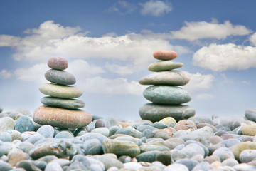 two stacks of stones over over sky background