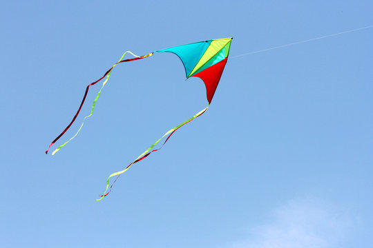 color bright kite in the blue sky