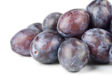 Obraz premium Fresh appetizing plums on a white background