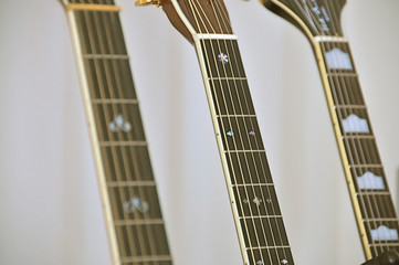 Closeup of fretboards of guitars