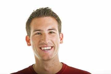 Obraz premium A young guy with a nice smile on a white background