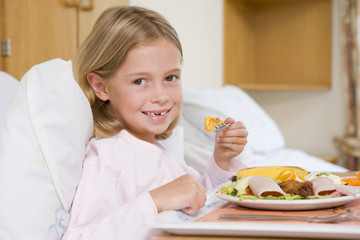 Obraz na płótnie Canvas Young Girl Eating Hospital Food