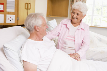 Fototapeta na wymiar Senior Woman Visiting Her Husband In Hospital