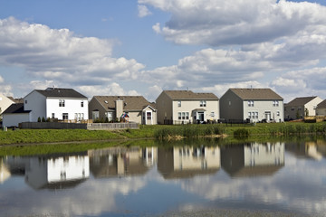 Suburban community reflected in the pond.