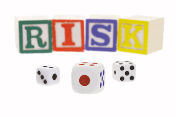 Gambling dice and letter blocks arranged to form the word 