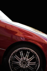 A closeup of a chrome rim on a modern luxury sedan