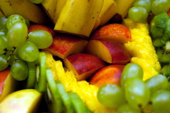 fruit background from bananas aples vine and kiwi