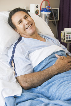 Middle Aged Man Lying In Hospital Bed