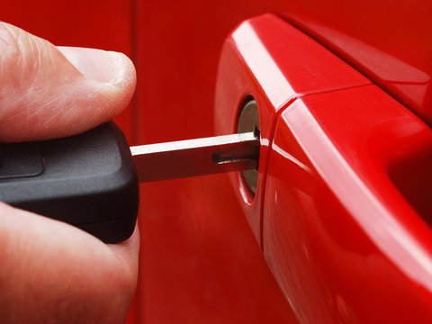 Extreme Close-up Of Man Inserting Key Into Car Lock