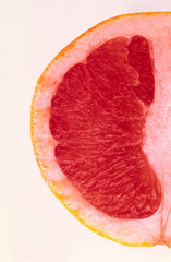 Slice  red color grapefruit on  white background,  close up.