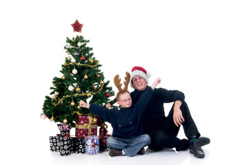 Christmas, happy father and son next to Xmas tree
