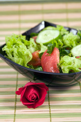Fresh vegetables salad and red rose