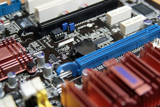 close-up photo of computer motherboard with lithium battary