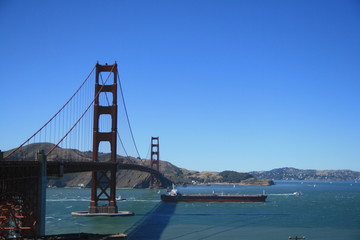 Ship swims under Golden Gate Bridge