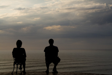 a couple sitting on two chairs