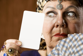 Gypsy fortune teller hiolding a blank tarot card