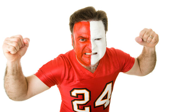 Angry sports fan with a painted face, raising his fists