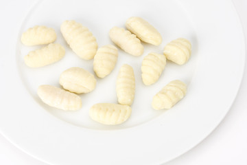 uncooked gnocchi noodles on a plate