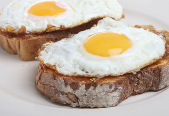 Two fried eggs on crusty toasted bread