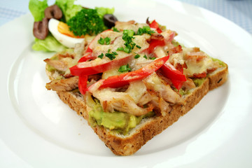 Grilled open chicken sandwich with avocado and peppers