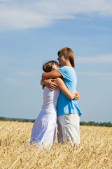 Photo of loving couple in sweet embrace on the field